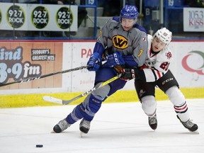 Sudbury Wolves defenceman Reagan O'Grady fights off a Niagara IceDogs player during OHL action at Sudbury Community Arena on Sunday afternoon. The Wolves lost 5-4. Gino Donato/The Sudbury Star