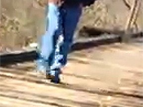 This Feb. 13, 2017, photo released by the Indiana State Police shows a man walking along the trail system in Delphi, Ind. Indiana authorities want to talk to the man in connection with the killings of two teenage girls. He was photographed on the trail system around the time Liberty German and Abigail Williams were dropped off Monday to go hiking. (Indiana State Police via AP)