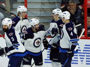 Winnipeg Jets' Mathieu Perreault (85)celebrates his goal with teammates Mark Stuart (5), Patrick Laine (29), Mark Scheifele (55) and Paul Postma (4)during first period NHL hockey action against the Senators in Ottawa on Sunday, February 19, 2017. THE CANADIAN PRESS/Fred Chartrand