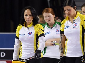 Manitoba skip Michelle Englot (left) talks strategy with third Kate Cameron as Saskatchewan third Deanna Doig, middle back, and skip Penny Barker look on during the 3rd draw of the Scotties Tournament of Hearts in St. Catharines, Ont., on Sunday, Feb. 19, 2017. (THE CANADIAN PRESS/Sean Kilpatrick)