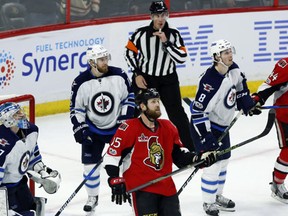 Ottawa Senators and Winnipeg Jets players look up at the replay as a play during the last seconds of the game was under review during third period NHL hockey action in Ottawa, Sunday February 19, 2017. (THE CANADIAN PRESS/Fred Chartrand)