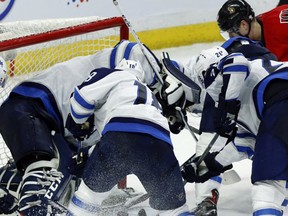 Ottawa Senators' Jean-Gabriel Pageau tries to jam the puck past Winnipeg Jets goaltender Connor Hellebuyck during third period NHL hockey action in Ottawa, Sunday February 19, 2017. (THE CANADIAN PRESS/Fred Chartrand)