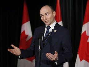 Social Development Minister Jean-Yves Duclos speaks to reporters at a Liberal cabinet retreat in Calgary Jan. 24, 2017.  THE CANADIAN PRESS/Todd Korol