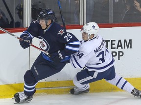 Winnipeg Jets right winger Patrik Laine (l) takes down Toronto Maple Leafs center Auston Matthews during NHL hockey in Winnipeg, Man. Wednesday October 19, 2016. Brian Donogh/Winnipeg Sun/Postmedia Network