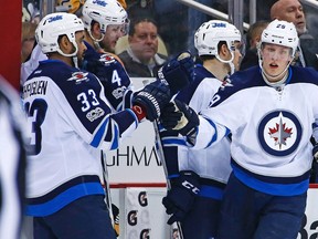 Winnipeg Jets' Patrik Laine (29) celebrates his goal with Dustin Byfuglien (33) as he returns to the bench during the second period of the team's NHL hockey game against the Pittsburgh Penguins in Pittsburgh on Feb. 16, 2017. NHL rookie classes like this one don't come around very often. It's been almost 25 years since we last saw three rookies hit both the 20-goal and 70 point plateaus in the same season (1992-93). Auston Matthews, Patrik Laine and Mitch Marner are all on pace to do it this year. THE CANADIAN PRESS/AP, Gene J. Puskar
