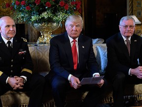 U.S. President Donald Trump, centre, sits with Army Lt. Gen. H.R. McMaster, left, and retired Army Lt. Gen. Keith Kellogg, right, at Trump's Mar-a-Lago estate in Palm Beach, Fla., Monday, Feb. 20, 2017, where Trump announced that McMaster will be the new national security adviser. Kellogg, who had been his acting adviser, will now serve as the National Security Council chief-of-staff. (AP Photo/Susan Walsh)