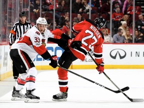Fredrik Claesson of the Ottawa Senators trips up Stefan Noesen of the New Jersey Devils on Feb. 16, 2017 at Prudential Center. (Elsa/Getty Images)