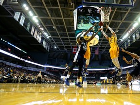 Marvin Phillips and teammate Joel Friesen both reach for an offensive rebound in front of Kore White of the Halifax Hurricane during a game at Budweiser Gardens earlier this year.  Mike Hensen/The London Free Press/Postmedia Network