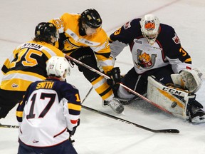 Kingston Frontenacs Ted Nichol and Linus Nyman battle to get the puck past Barrie Colts goaltender Christian Propp during the third period of Ontario Hockey League action at the Rogers K-Rock Centre on Monday. The Frontenacs won 5-1. (Julia McKay/The Whig-Standard)