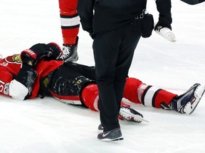 Ottawa Senators' Mark Stone lies injured on the ice after being hit hard by Winnipeg Jets' Jacob Trouba during an NHL game on Feb. 19, 2017. (THE CANADIAN PRESS/Fred Chartrand)
