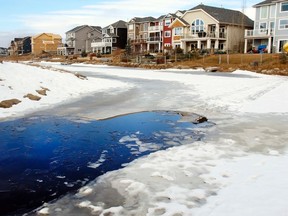 Two children ages six and 10 were rushed to hospital after the pair fell through the ice along a walking path near Bayside Point SW Airdrie, Alta., on February 20, 2017. Ryan McLeod/Postmedia Network