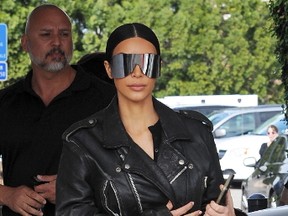 Kim Kardashian spotted wearing a black leather jacket with back to the future sunglasses while filming her reality show with sister Kourtney Kardashian at Casa Vega restaurant in Studio City. (Cousart/JFXimages/WENN.com)