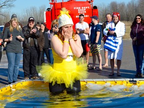 Petrolia’s Dr. Lisa Thompson reacts as she tests icy cold waters during a recent polar dip in the community. The event raised over $5,000 for safeTALK training, to instruct individuals on how to react when someone shows signs of depression. Melissa Schilz/Postmedia Network