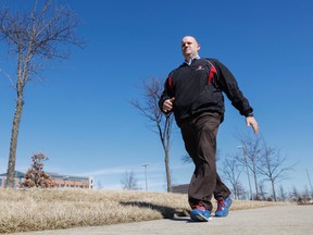 In this Monday, Feb. 29, 2016, photo, Brett Broviak, a manager of respiratory and sleep services at IU Health North Hospital, walks with his Fitbit fitness tracker on the hospital’s campus in Carmel, Ind. (AP Photo/AJ Mast)
