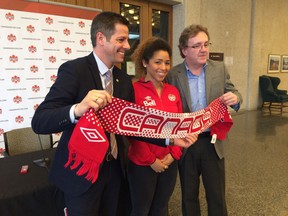 Canadian national women's soccer team member Desiree Scott with Winnipeg Mayor Brian Bowman (left) and president of Manitoba soccer Peter Muir (right) at the announcement that Winnipeg will play host to a Canada-Costa Rica soccer friendly in June at a press conference at City Hall on Feb. 21, 2017. Paul Friesen/Winnipeg Sun