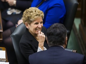 Ontario Premier Kathleen Wynne chats as the Legislative session resumes after the winter break at Queen's Park in Toronto on Tuesday, Feb. 21, 2017. (Ernest Doroszuk/Toronto Sun)