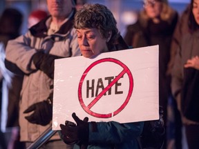 A woman holds a sign during a rally against Islamophobia in Vancouver, B.C., on Saturday February 4, 2017. (THE CANADIAN PRESS/Ben Nelms)