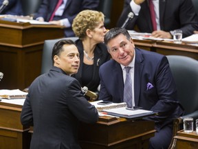 Ontario Premier Kathleen Wynne and Finance Minister Charles Sousa (right) and Ontario Minister of Economic Development and Growth Brad Duguid (front) look on as the Legislative session resumes after the winter break at Queen's Park in Toronto on Tuesday, Feb. 21, 2017. (Ernest Doroszuk/Toronto Sun)