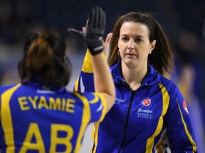 Alberta alternate Heather Nedohin gives third Lisa Eyamie a high five after a win over Saskatchewan during the Scotties Tournament of Hearts in St. Catharines, Ont., on Feb. 21, 2017. (THE CANADIAN PRESS/Sean Kilpatrick)