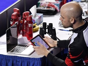 Adam Kingsbury, coach of Rachel Homan’s Ontario team, works with a computer as he monitors his team’s play during the Scotties Tournament of Hearts in St. Catharines, Ont..(SEAN KILPATRICK/The Canadian Press)