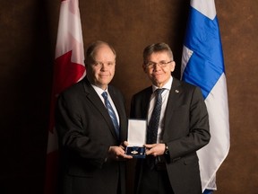 His Excellency Vesa Lehtonen, right, Ambassador of Finland to Canada, presents Kevin McCormick, president and vice-chancellor of Huntington University, with the Knight, First Class, of the Order of the White Rose of Finland on Feb. 21. Supplied photo