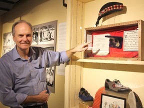 Mike Baker, curator at the Elgin County Museum, shows the Malahide Medal, one of the oldest curling trophies still competed for in the country