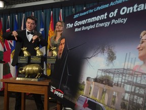 Canadian Taxpayers Federation Federal Director Aaron Wudrick gives the thumbs down after announcing the winners of the 19th annual Teddy Waste Awards during a news conference in Ottawa, Wednesday February 22, 2017. The CTF awards recognize government spending waste. THE CANADIAN PRESS/Adrian Wyld