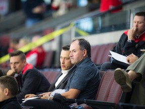 Pierre Dorion, GM of the Ottawa Senators, sits in the stands watching an intrasquad game at the annual Senators Fanfest on Sept. 25, 2016 at the Canadian Tire Centre. (Ashley Fraser/Postmedia)