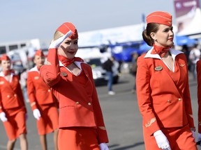 Cabin crew of the Russian airline Aeroflot walk past during the International Paris Airshow at Le Bourget on June 16, 2015. The airline has hit turbulence over a new edict grounding 400 “old, fat and ugly” flight attendants. (AFP/PHOTO)