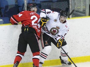 Sarnia Legionnaires forward Curtis Egert eyes the puck while Leamington Flyer Jaydon Fetter checks him during a Greater Ontario Junior Hockey League game at Sarnia Arena earlier this season. The teams will meet in the first round of the playoffs. (Terry Bridge/Sarnia Observer)