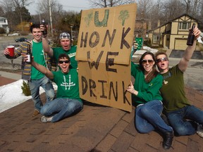 Western University students party on the rooftop on Castlegrove Blvd. with their sign to mark St. Patrick's day in London, Ontario on Thursday March 17, 2011. (Free Press file photo)