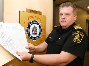 Luke Hendry/The Intelligencer
Belleville Fire Chief Mark MacDonald holds some of the paperwork related to ongoing orders his department has issued against the ownership of Bel Marine Retirement Residence Wednesday. He said agencies have spent years trying to force various owners to comply with various regulations, including electrical and fire hazards.