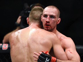 Rory MacDonald embraces Stephen Thompson after their welterweight main event during UFC Fight Night: MacDonald vs. Thompson at TD Place Arena on June 19, 2016. (Darren Brown/Postmedia)