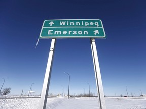 A highway sign near the Canada-U.S. crossing points the way to Winnipeg and to the border town of Emerson.