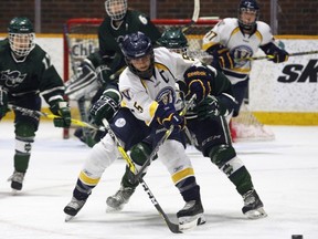 Laurentian Voyageurs captain Ellery Veerman (5) battles for the puck during the second period of OUA McCaw Cup quarterfinal playoff action against the host Nipissing Lakers at Memorial Gardens in North Bay, Wednesday. Laurentian heavily out-shot the Lakers but lost 5-2, Nipissing's win capped by two empty-net goals as the Voyageurs tried to even the score. The second game of the best of three series is Saturday at Countryside Arena at 7:20 p.m.