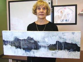 Joan Armstrong, with Community Concerns for the Medically Fragile in Sarnia, is show on Thursday holding one of the pieces of art in this year's 10th anniversary Celebrities on Canvas gala, set for April 22.
 (Paul Morden/Sarnia Observer)