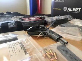 Weapons, ammo, drugs and vests are displayed by the Alberta Law Enforcement Response Team during a press conference at the Wood Buffalo RCMP detachment in Fort McMurray, Alta. on Thursday, Feb. 23, 2017. Vincent McDermott/Postmedia Network