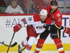 Calgary Flames captain Mark Giordano holds up Bryan Bickell of the Carolina Hurricanes during an NHL game on Oct. 19, 2016. (Ted Rhodes/Postmedia)