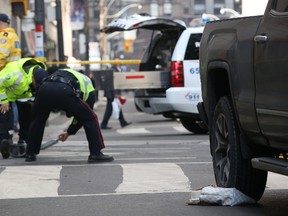 A pedestrian is in life-threatening condition after being struck by a pick-up truck at Bay and Adelaide in downtown Toronto on Thursday, Feb. 23, 2017. (Stan Behal/Toronto Sun)