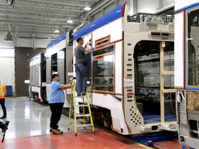 Ian MacAlpine/The Whig-Standard
Bombardier employees work on a Metrolinx train car as officials at Bombardier Inc. invited the media to their Loyalist Township facility on Wednesday to report that everything is on track as far as they are concerned for the $770-million Toronto-area Metrolinx project.