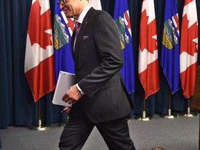 Sporting a leg brace, Alberta Finance Minister Joe Ceci walks away from the podium after a news conference to talk about the province's third quarter fiscal update at the Legislature in Edmonton, Thursday, February 23, 2017.  Ed Kaiser/Postmedia