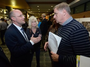 Mayor Matt Brown speaks to Elaine Sawyer and Mike Smith, both members of London?s business community, during a public information meeting on the city?s rapid transit proposal Thursday at the Central Library. (MORRIS LAMONT, The London Free Press)