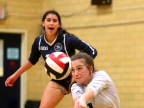 Taylor Mizzi of the Lucas Vikings bumps up a spike with teammate Hailey Knox behind her during their WOSSAA championship in senior girls volleyball held at Oakridge Secondary School in London, Ont. on Thursday February 23, 2017.  (MIKE HENSEN, The London Free Press)