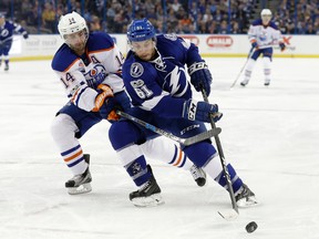 Edmonton Oilers right wing Jordan Eberle knocks the puck away from Tampa Bay Lightning center Gabriel Dumont on Tuesday, Feb. 21, 2017, in Tampa, FL. (Chris O'Meara/AP Photo)