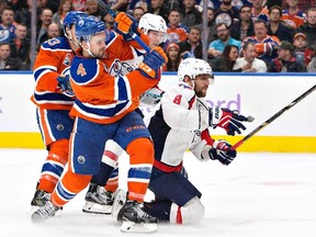 Washington Capitals' Alex Ovechkin (8) is taken down by Edmonton Oilers' Kris Russell (4) in Edmonton on Oct. 26, 2016. (The Canadian Press)