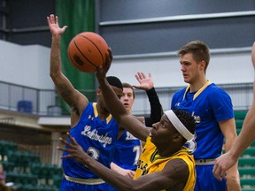 University of Alberta Golden Bears' Mamadou Gueye dives for the ball against the University of Lethbridge Pronghorns during the first game in the best of three Canada West quarter-final series on Thursday, Feb. 23, 2017, at the Saville Community Sports Centre. (Greg Southam)