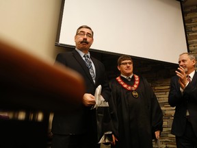 Steve Gatward ( first from left) is thanked for his service by Rodney Cooney (centre) and Hastings County CAO Jim Pine.