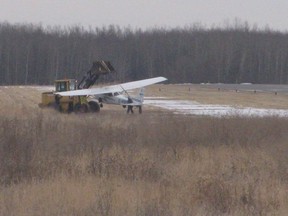 A damaged plane is carried away after an accident at the Parkland Airport on Feb. 18. - Photo supplied