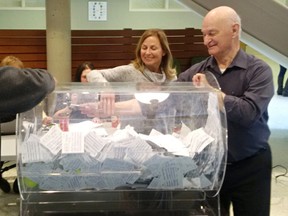 Bluewater Health Foundation board member Denise Kohlmeier draws a ticket for a $500 prize at the Dream Home Lottery draw at Bluewater Health in Sarnia Friday. Board member Leo Lozier looks on. The 22nd annual fundraising lottery for the Bluewater Health Foundation brought in about $300,000 to help pay for new medical equipment. (Submitted)