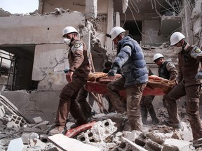 MSALLAM ABDALBASET/Getty Images
Syrian civil defence volunteers, known as the White Helmets, search for survivors following a reported government airstrike on the rebel-held neighbourhood of Tishrin, on the northeastern outskirts of the capital Damascus on Feb. 22.